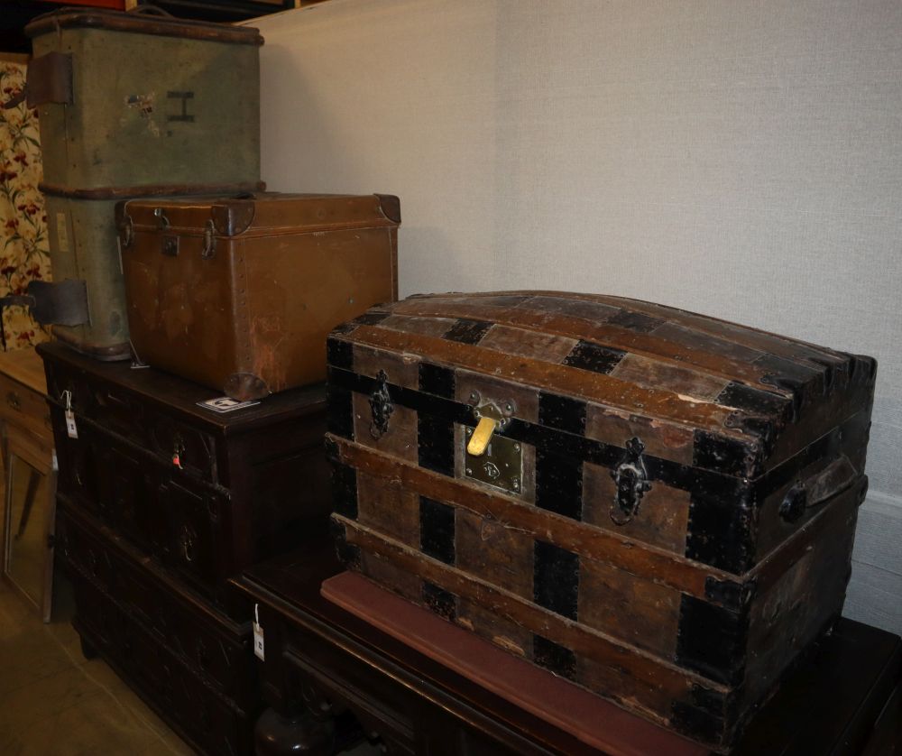 An early 20th century metal bound domed topped steamer trunk, W.76cm, a leather bound trunk and another